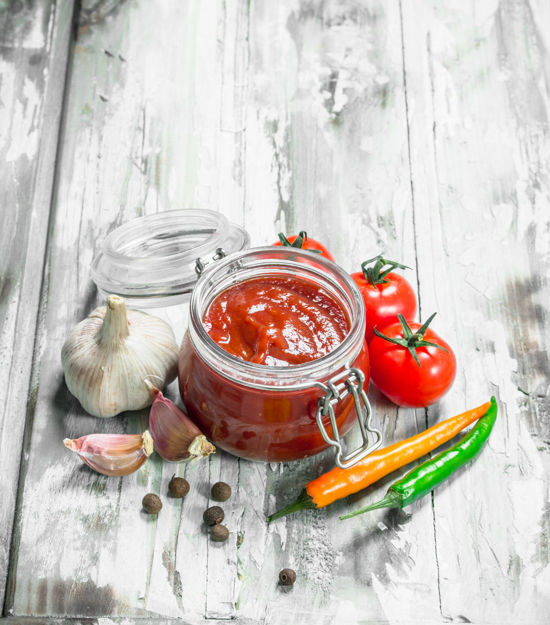 Tomato sauce in a jar and spices.